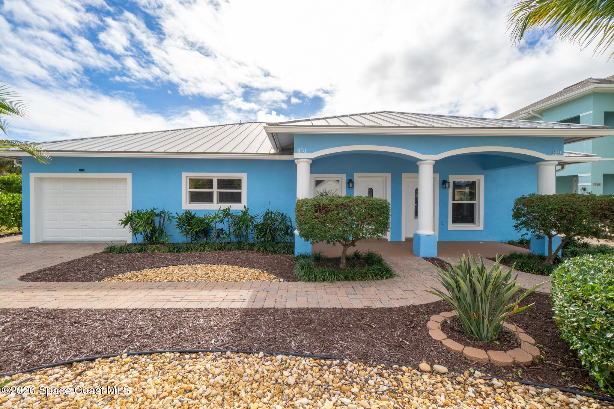 131 Harding Avenue, Unit 131 & 129 Cocoa Beach, FL 32931 - Photo 45 of 47 a front view of a house with garden
