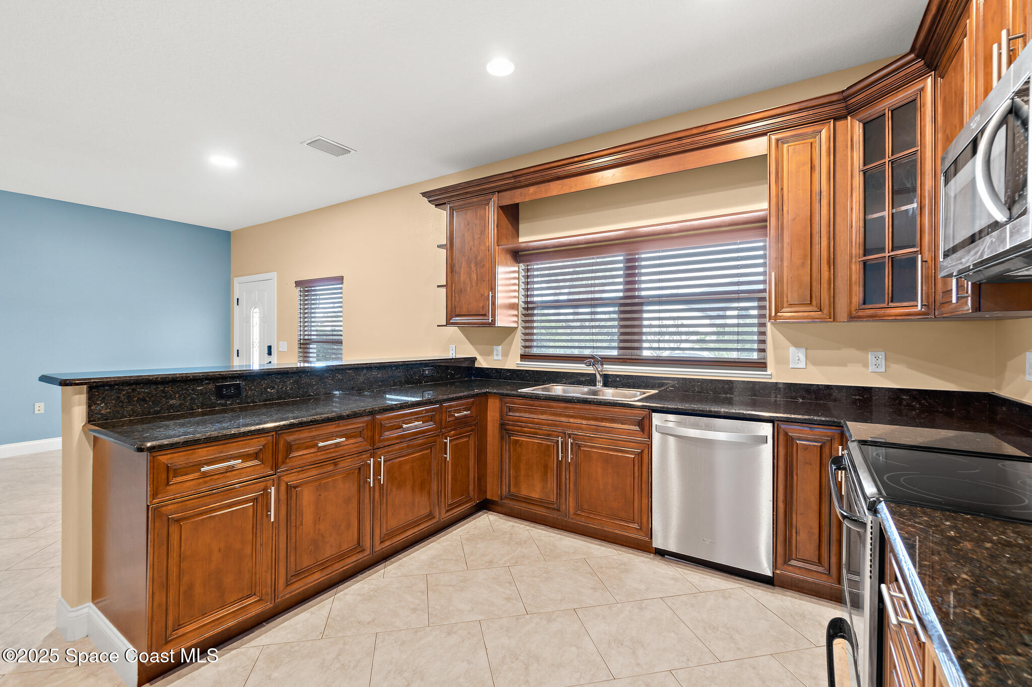 131 Harding Avenue, Unit 131 & 129 Cocoa Beach, FL 32931 - Photo 5 of 47 a kitchen with stainless steel appliances granite countertop a sink and a stove