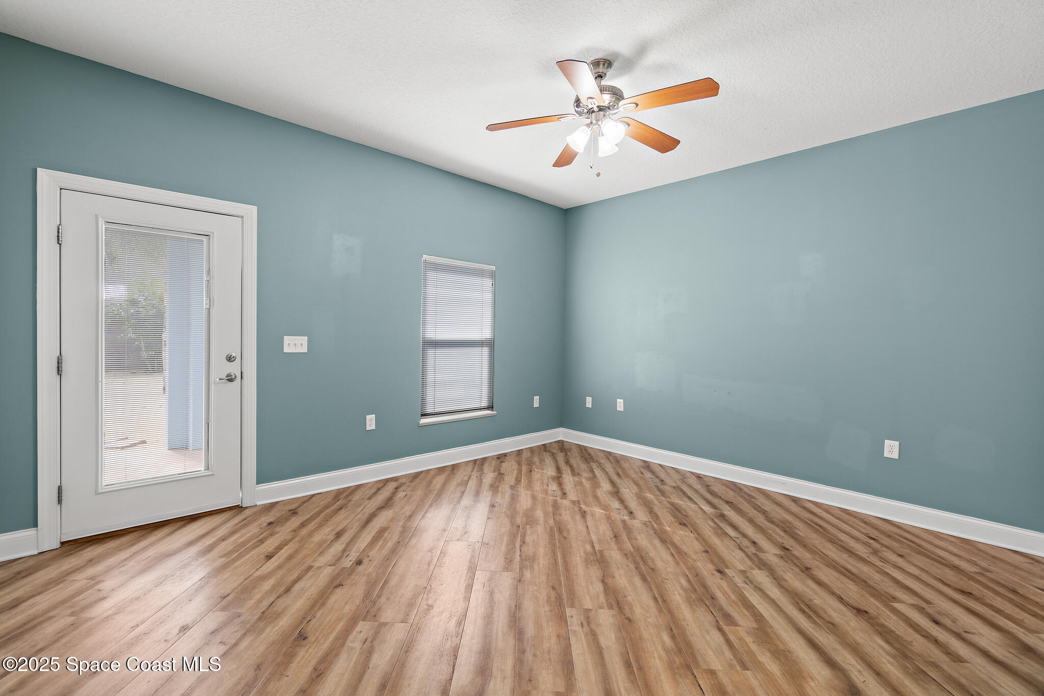 131 Harding Avenue, Unit 131 & 129 Cocoa Beach, FL 32931 - Photo 8 of 47 wooden floor in an empty room with a window