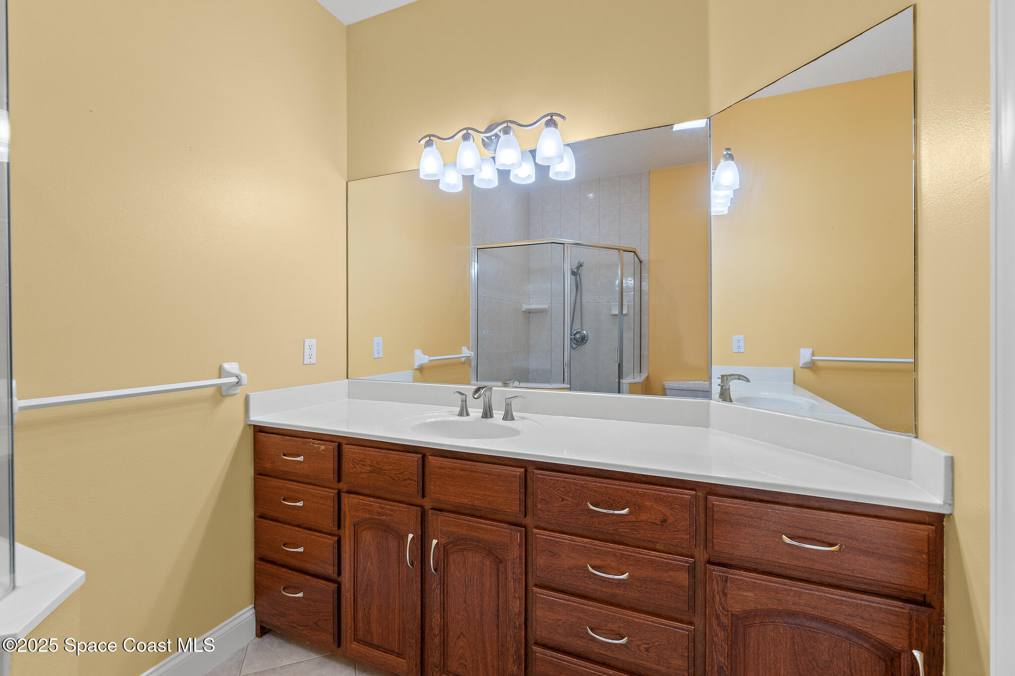 131 Harding Avenue, Unit 131 & 129 Cocoa Beach, FL 32931 - Photo 9 of 47 a bathroom with a sink vanity granite and a mirror