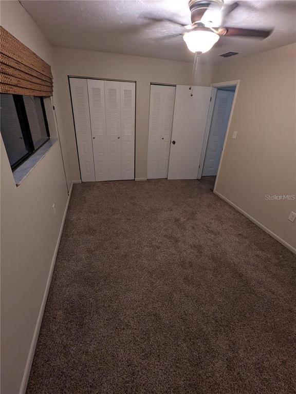 4317 Southwest 69 Terrace Gainesville, FL 32608 - Photo 15 of 23 a view of a livingroom with an empty space and a ceiling fan