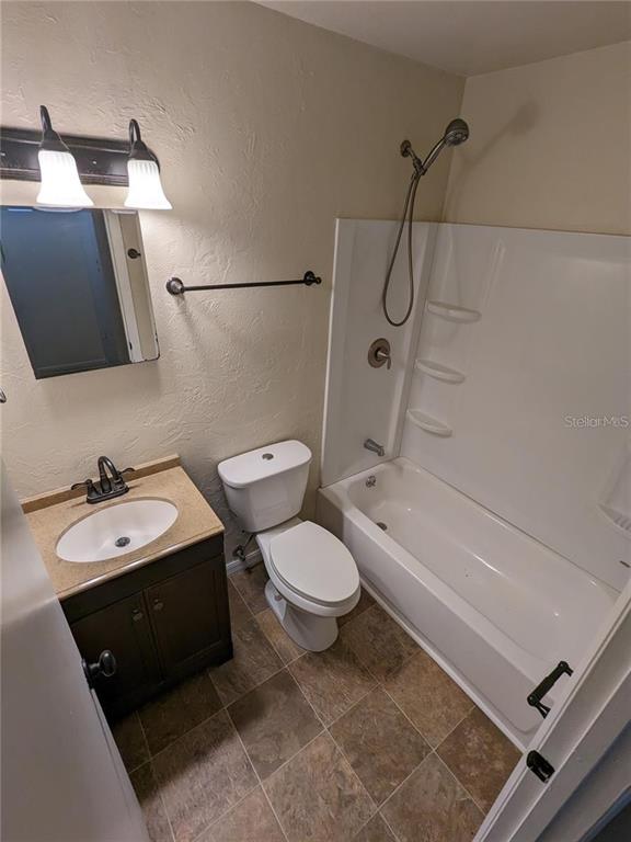4317 Southwest 69 Terrace Gainesville, FL 32608 - Photo 17 of 23 a bathroom with a sink a toilet a mirror and shower