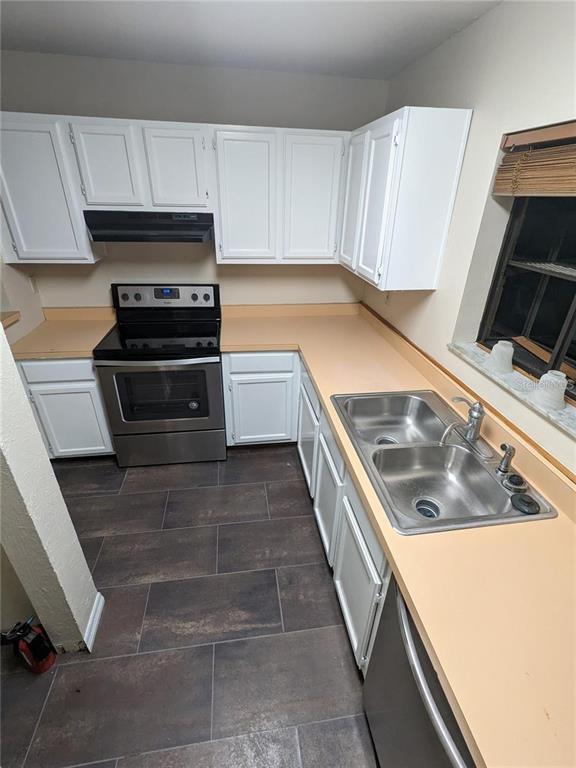 4317 Southwest 69 Terrace Gainesville, FL 32608 - Photo 3 of 23 a kitchen with a stove and a microwave