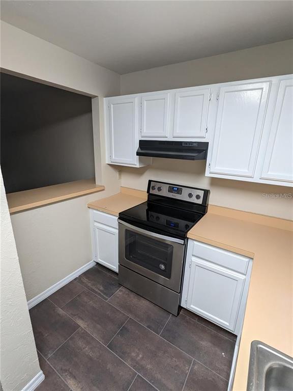 4317 Southwest 69 Terrace Gainesville, FL 32608 - Photo 4 of 23 a kitchen with a stove and a microwave