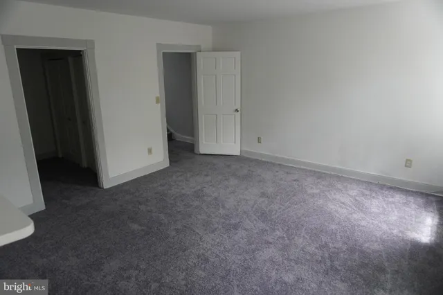 an empty room with closet area