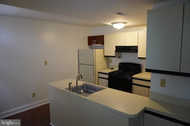 a kitchen with a sink and a refrigerator