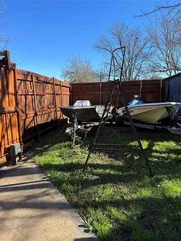 a backyard of a house with table and chairs