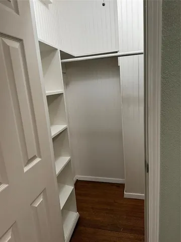 a view of walk in closet with empty racks