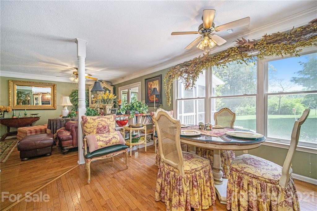 485 Mt Tabor Road Cleveland, NC 27013 - Photo 14 of 28 a dining room with furniture a chandelier and wooden floor