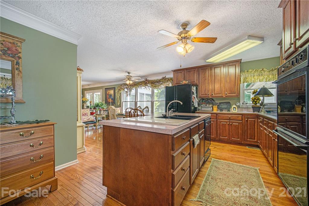 485 Mt Tabor Road Cleveland, NC 27013 - Photo 17 of 28 a kitchen with kitchen island granite countertop a stove and a sink