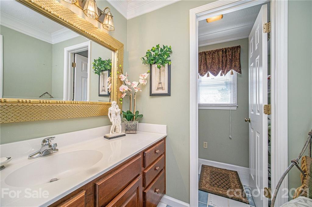 485 Mt Tabor Road Cleveland, NC 27013 - Photo 21 of 28 a bathroom with a sink and a mirror
