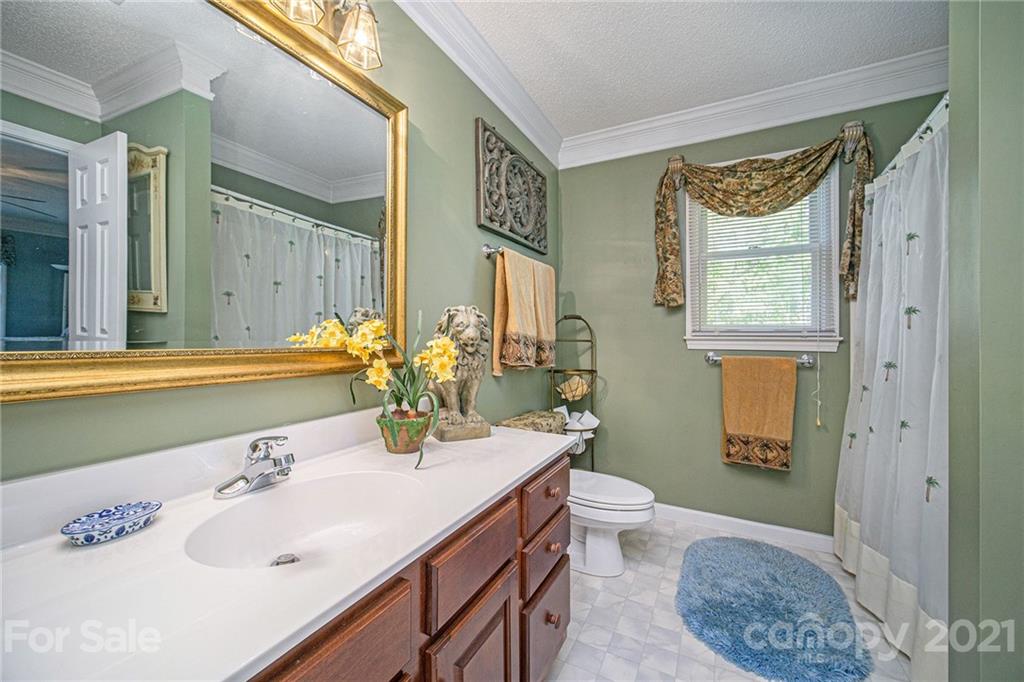 485 Mt Tabor Road Cleveland, NC 27013 - Photo 25 of 28 a bathroom with a granite countertop sink and a mirror