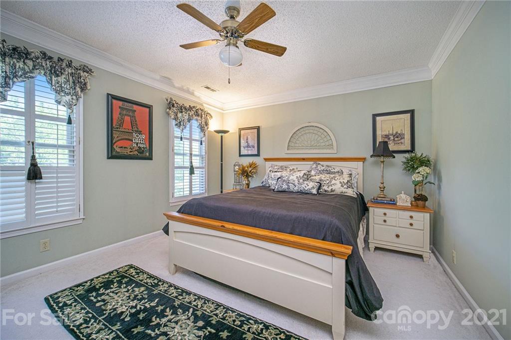 485 Mt Tabor Road Cleveland, NC 27013 - Photo 26 of 28 a bedroom with a large bed and a chandelier