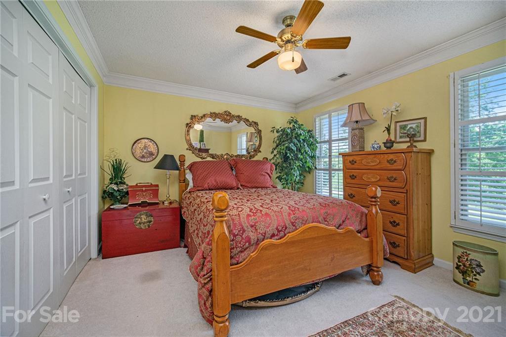 485 Mt Tabor Road Cleveland, NC 27013 - Photo 28 of 28 a bedroom with a bed and a chandelier