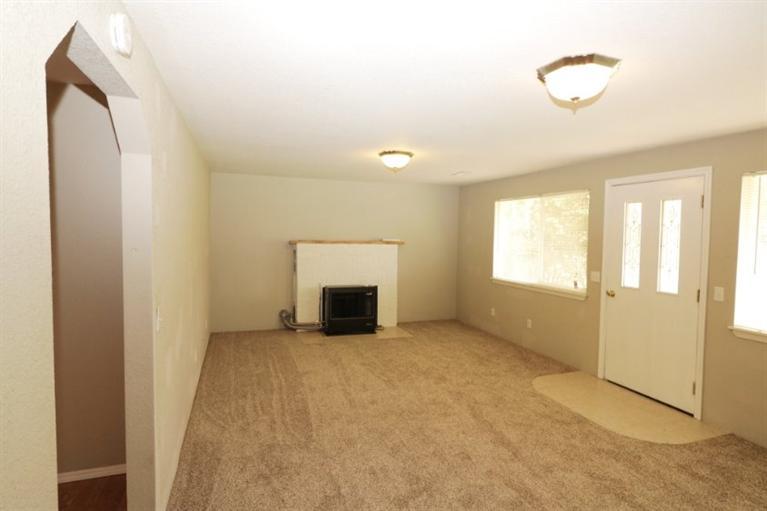 4782 Lower River Road Grants Pass, OR 97526 - Photo 5 of 28 a view of an empty room with a fireplace