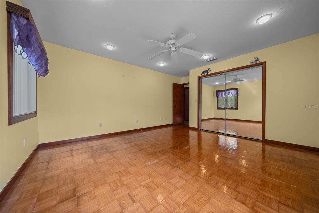 5950 Southwest 21st Avenue Road Ocala, FL 34471 - Photo 14 of 79 a view of an empty room with a window and wooden floor