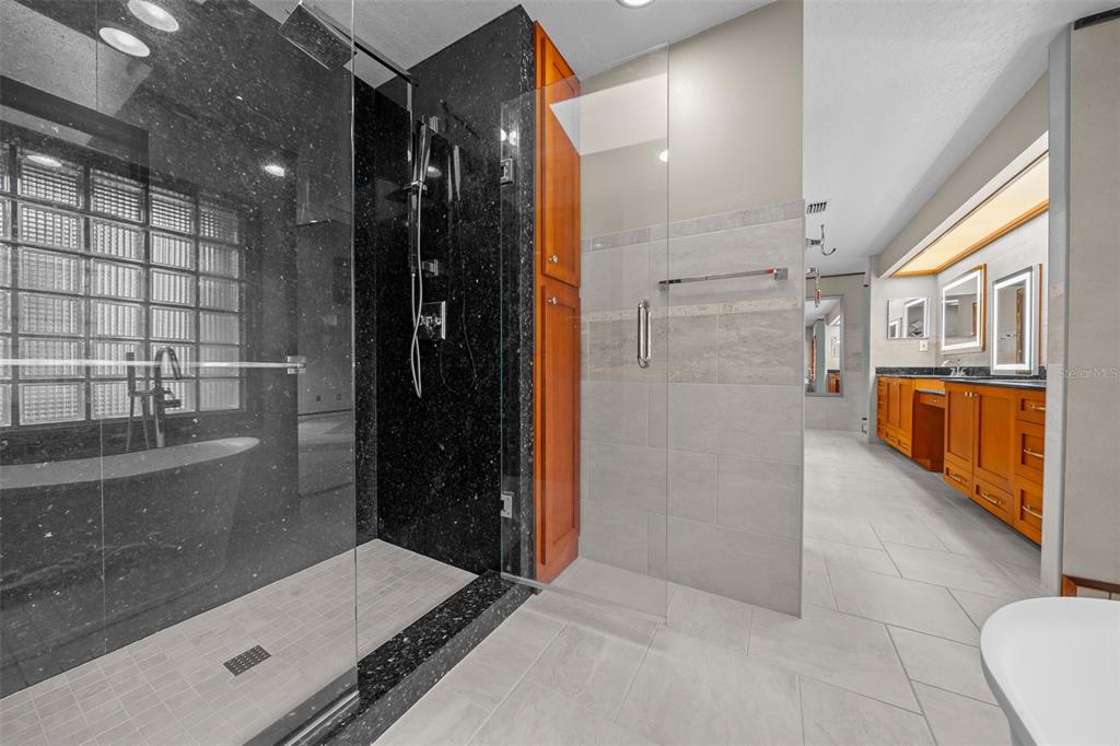 5950 Southwest 21st Avenue Road Ocala, FL 34471 - Photo 29 of 79 a bathroom with a glass door shower