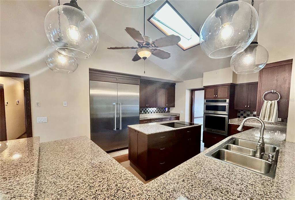 5950 Southwest 21st Avenue Road Ocala, FL 34471 - Photo 33 of 79 a kitchen with stainless steel appliances kitchen island granite countertop a sink refrigerator stove and microwave