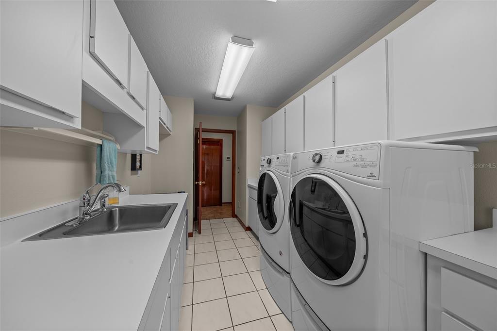 5950 Southwest 21st Avenue Road Ocala, FL 34471 - Photo 39 of 79 a utility room with sink dryer and washer