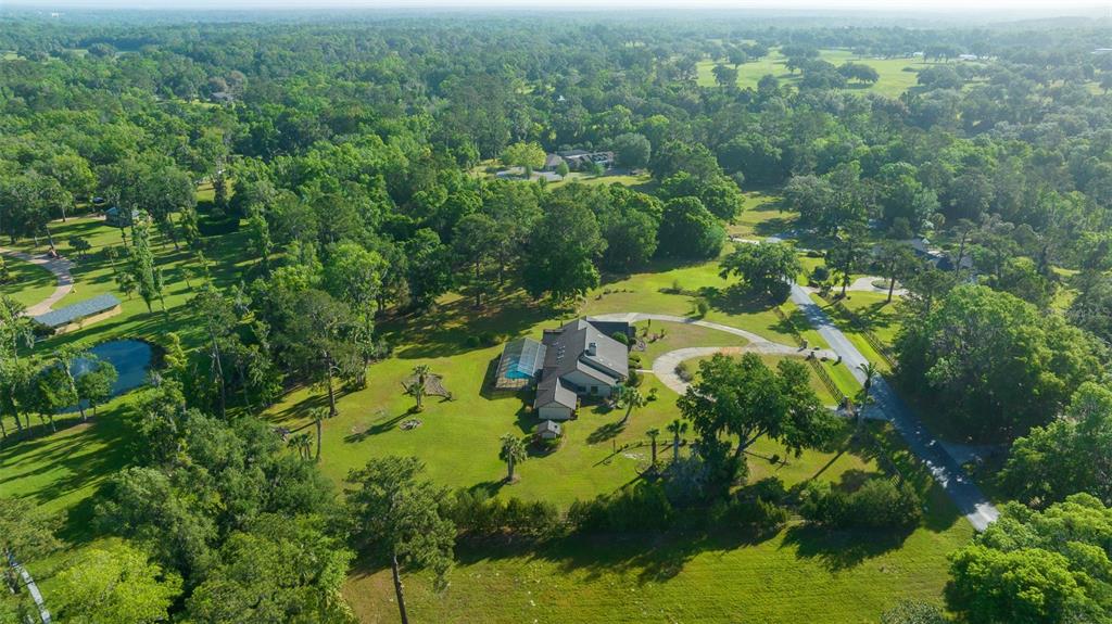 5950 Southwest 21st Avenue Road Ocala, FL 34471 - Photo 70 of 79 an aerial view of residential house with outdoor space and trees all around