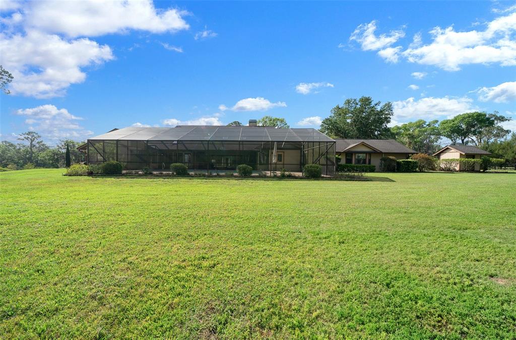 5950 Southwest 21st Avenue Road Ocala, FL 34471 - Photo 76 of 79 a view of a house with swimming pool and a yard
