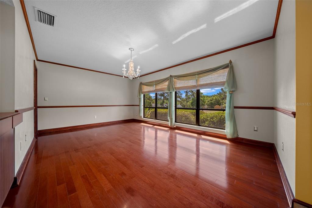 5950 Southwest 21st Avenue Road Ocala, FL 34471 - Photo 8 of 79 a view of an empty room with wooden floor and a window