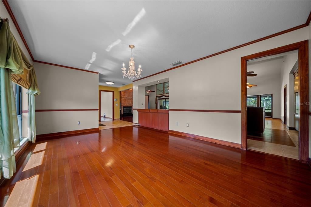 5950 Southwest 21st Avenue Road Ocala, FL 34471 - Photo 9 of 79 a view of a house with wooden floor