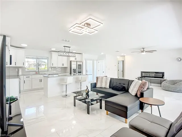 a living room with furniture and kitchen view