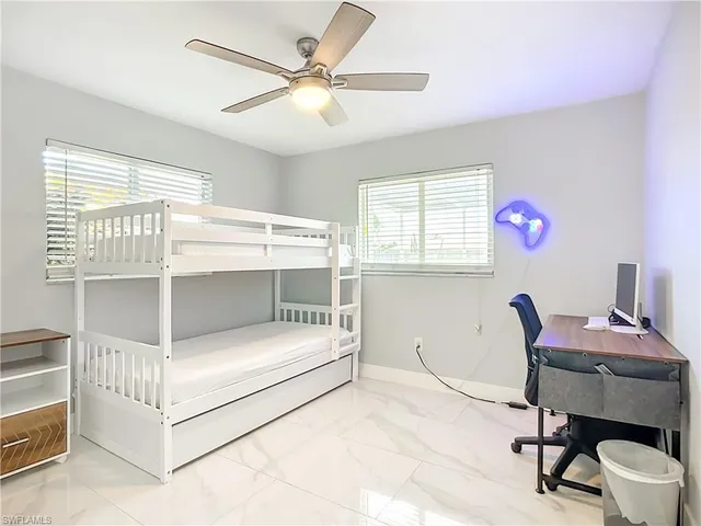 a bedroom with furniture and a window