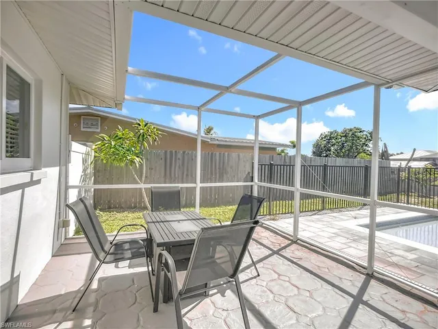 a patio with table and chairs