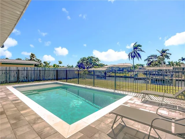 a view of a swimming pool with a lounge chair