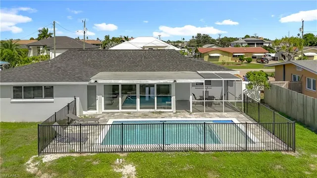 a view of a house with a backyard and a patio