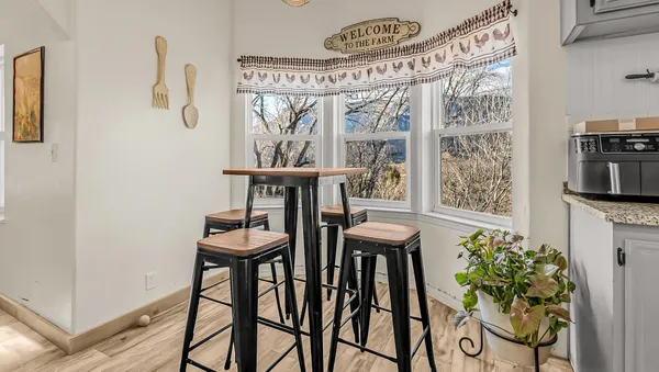 a view of a dining room with furniture window and wooden floor