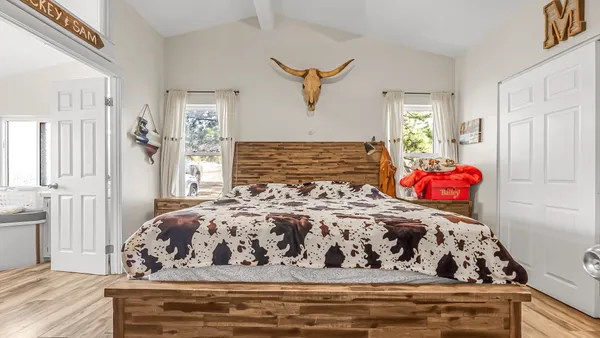 a bedroom with a bed and a window