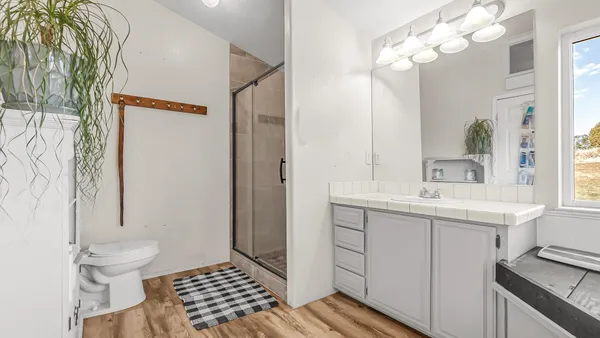 a bathroom with a sink a toilet and a mirror