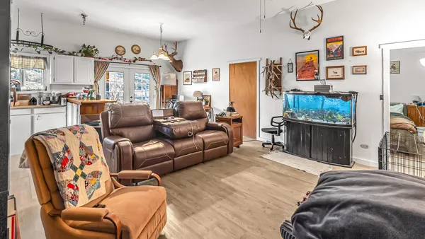 a bedroom with furniture and a flat screen tv