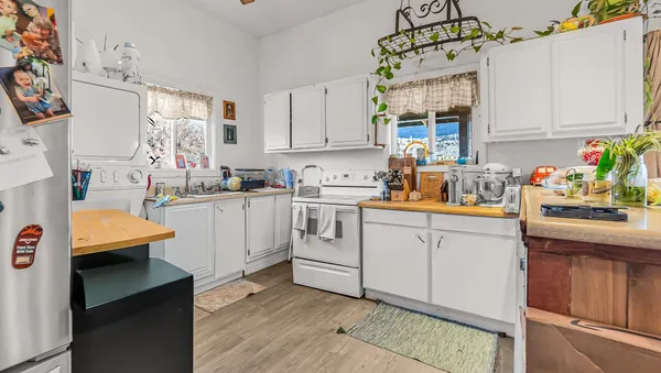 a utility room with cabinets washer and dryer