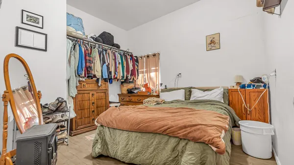a bedroom with furniture and a window
