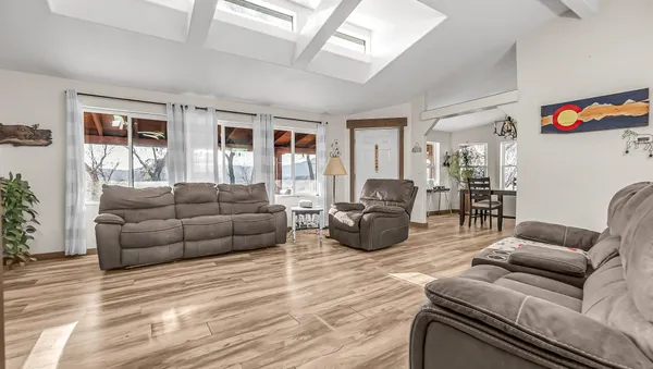 a living room with furniture kitchen and a table