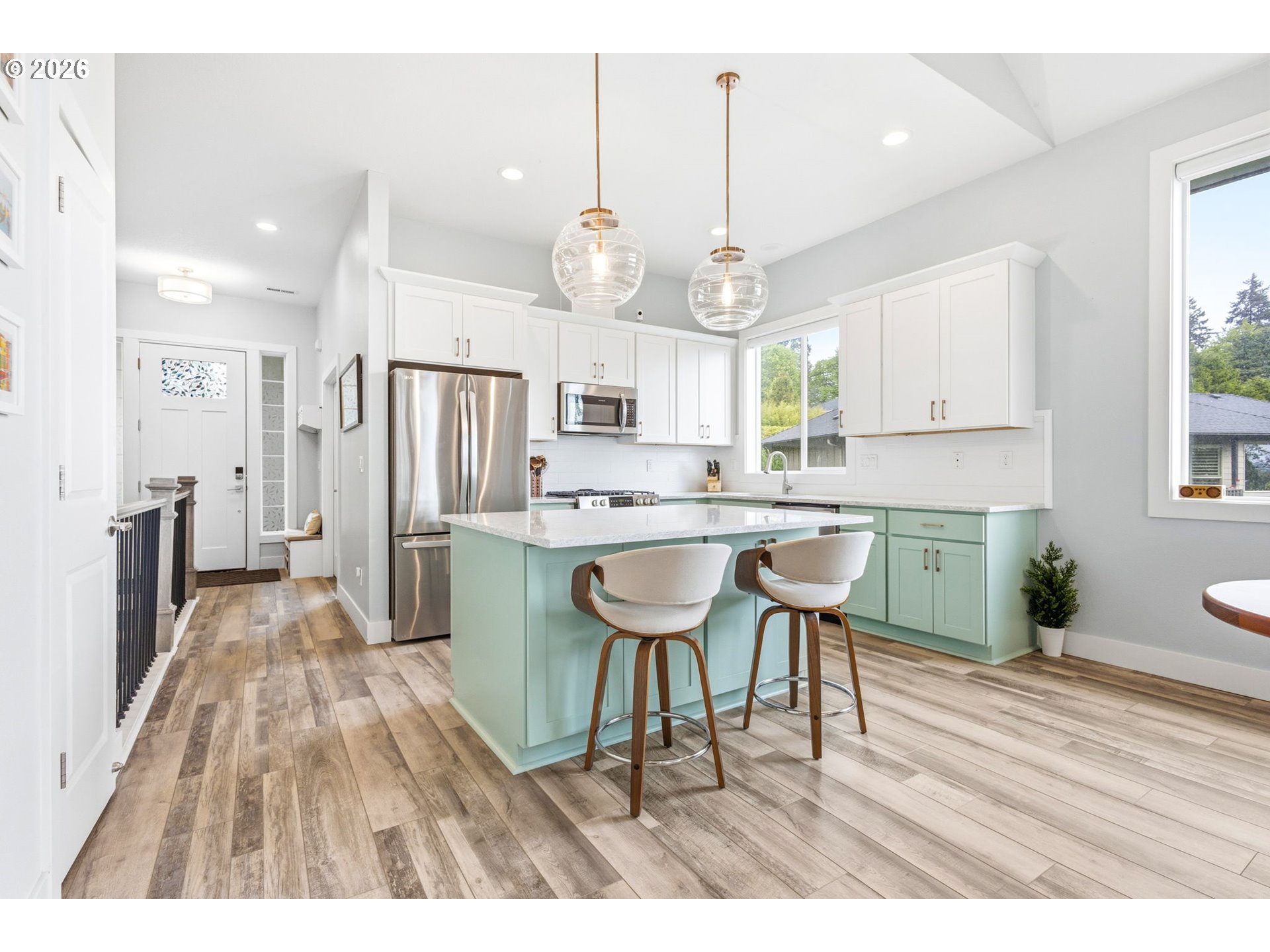 1372 Overview Street Northwest Salem, OR 97304 - Photo 12 of 45 a open kitchen with stainless steel appliances granite countertop a refrigerator a sink dishwasher a dining table and chairs with wooden floor
