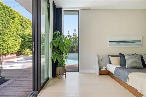 a bedroom with a bed and a potted plant
