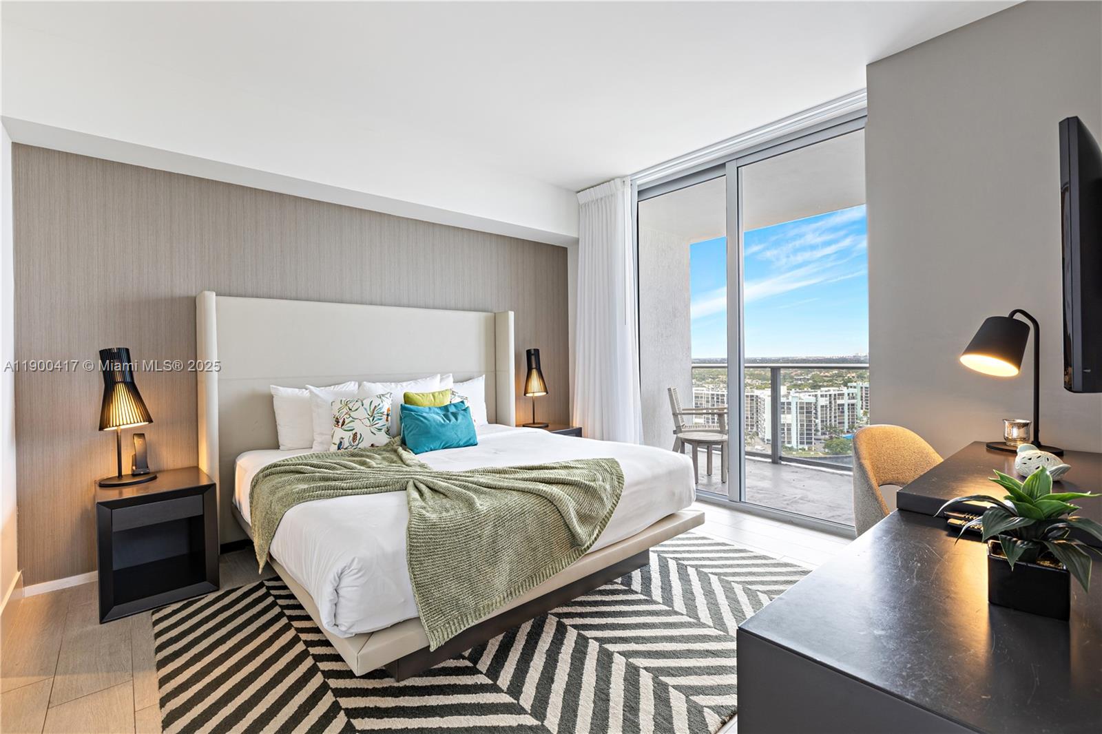 4010 South Ocean Drive, Unit R1701 Hollywood, FL 33019 - Photo 12 of 48 a bedroom with a bed and wooden floor