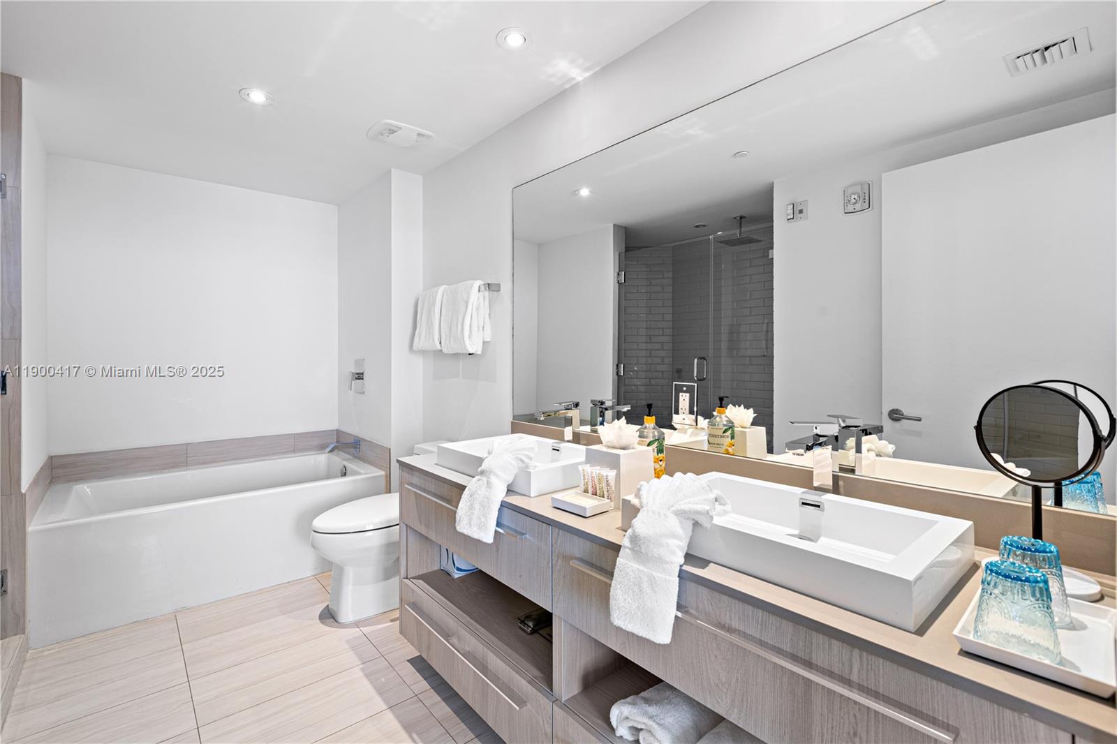 4010 South Ocean Drive, Unit R1701 Hollywood, FL 33019 - Photo 14 of 48 a bathroom with a double vanity sink mirror and toilet