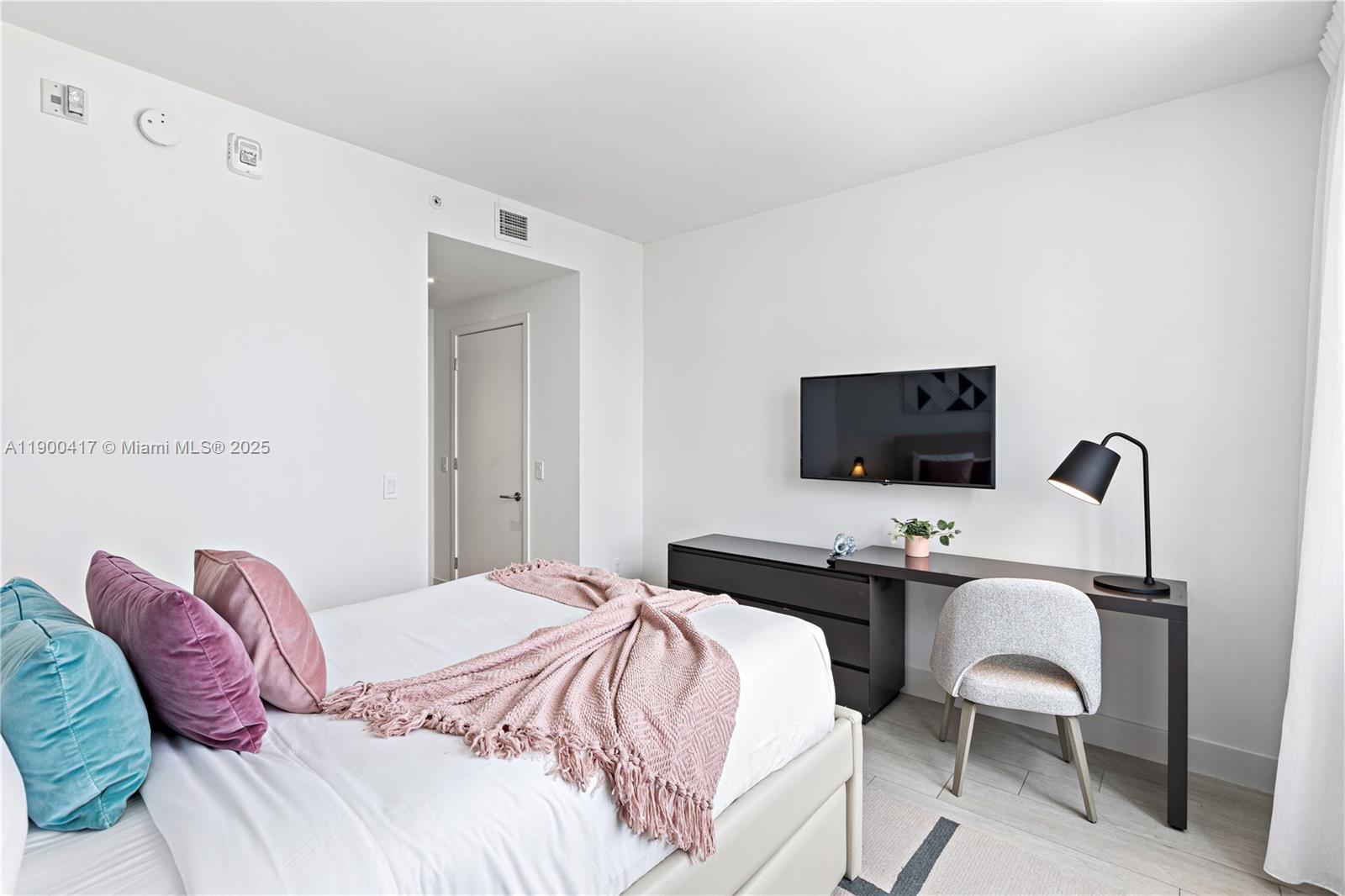 4010 South Ocean Drive, Unit R1701 Hollywood, FL 33019 - Photo 16 of 48 a bedroom with a bed and a table