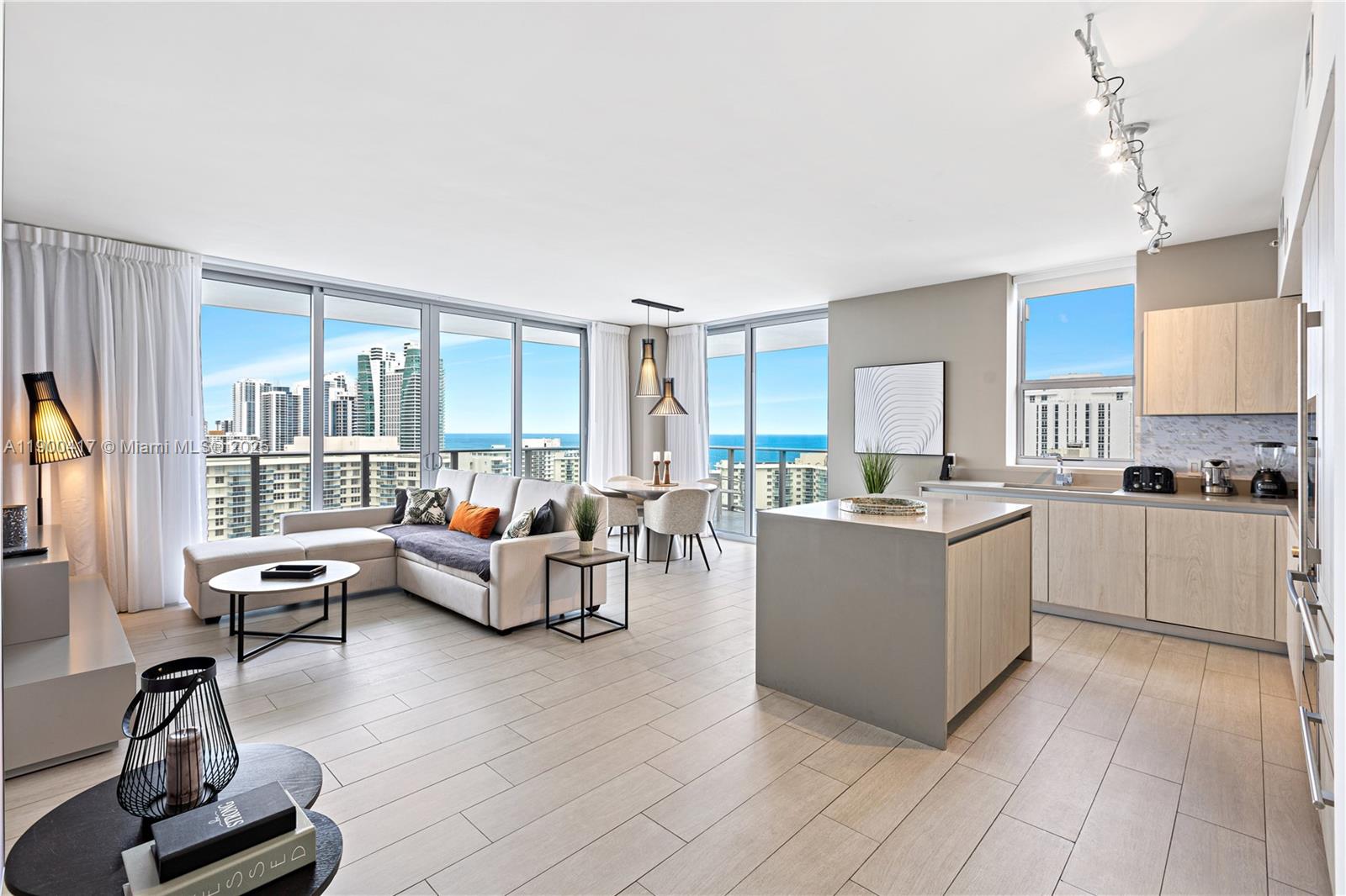 4010 South Ocean Drive, Unit R1701 Hollywood, FL 33019 - Photo 2 of 48 a living room with couches and kitchen view with wooden floor