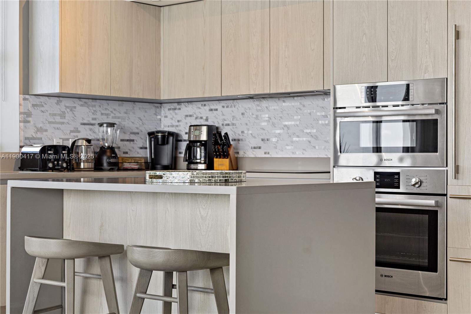 4010 South Ocean Drive, Unit R1701 Hollywood, FL 33019 - Photo 30 of 48 a kitchen with stainless steel appliances a sink and cabinets