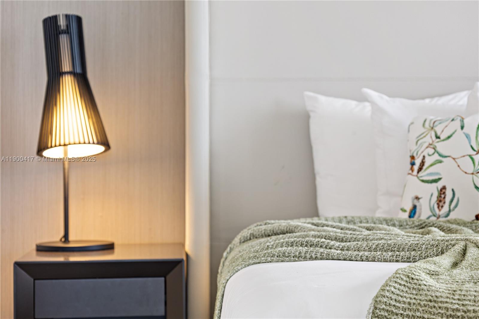 4010 South Ocean Drive, Unit R1701 Hollywood, FL 33019 - Photo 32 of 48 a bedroom with a bed and a lamp