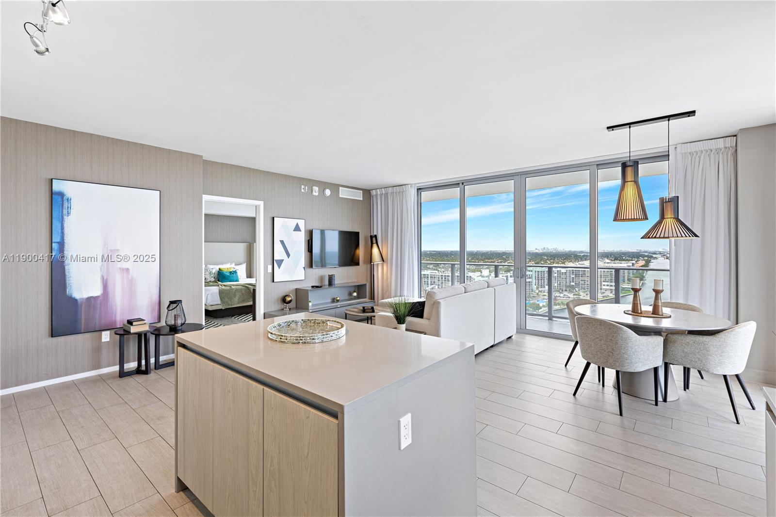 4010 South Ocean Drive, Unit R1701 Hollywood, FL 33019 - Photo 4 of 48 a view of a dining room with furniture a chandelier and wooden floor