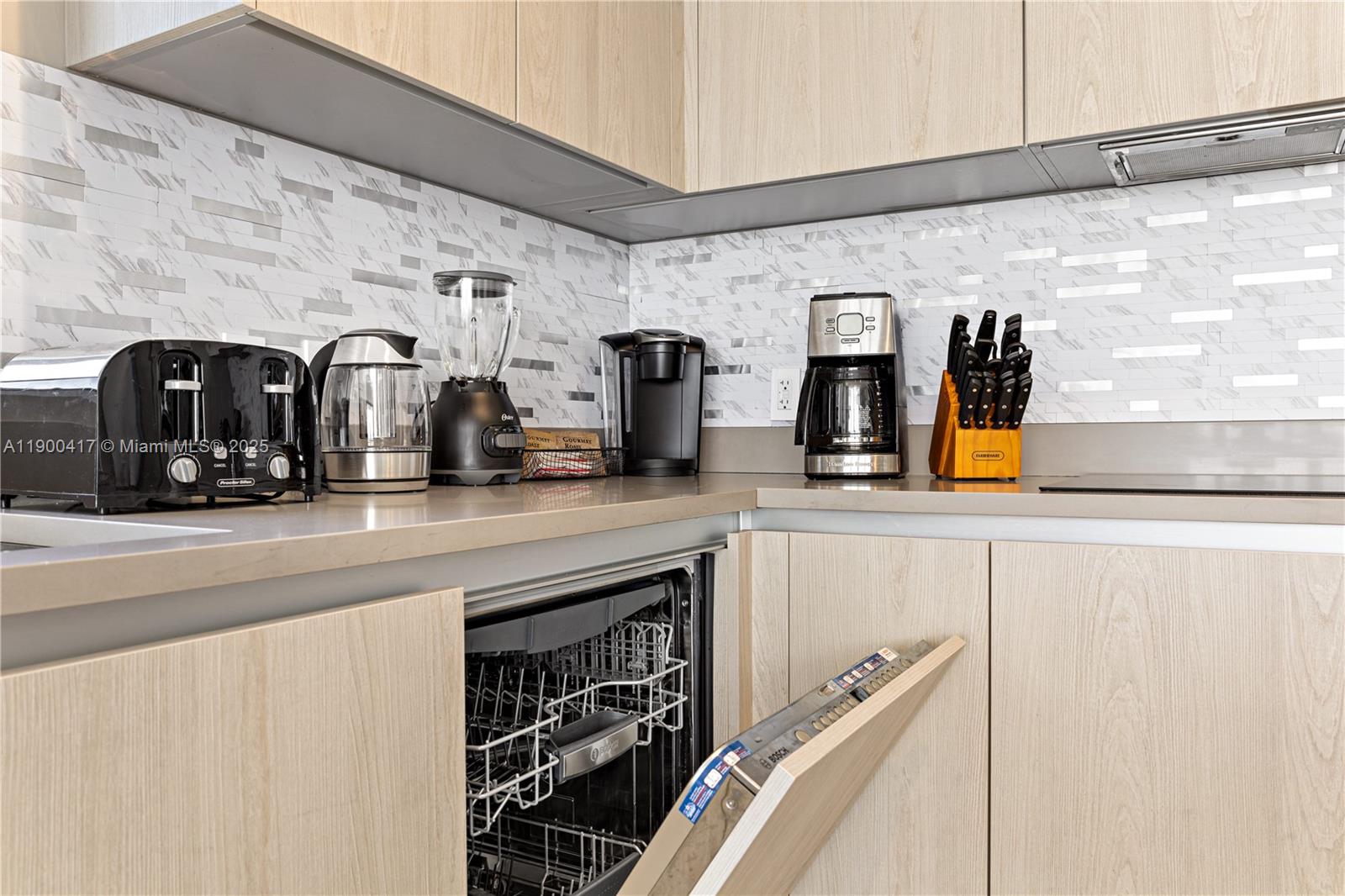 4010 South Ocean Drive, Unit R1701 Hollywood, FL 33019 - Photo 41 of 48 a kitchen with a refrigerator and a sink