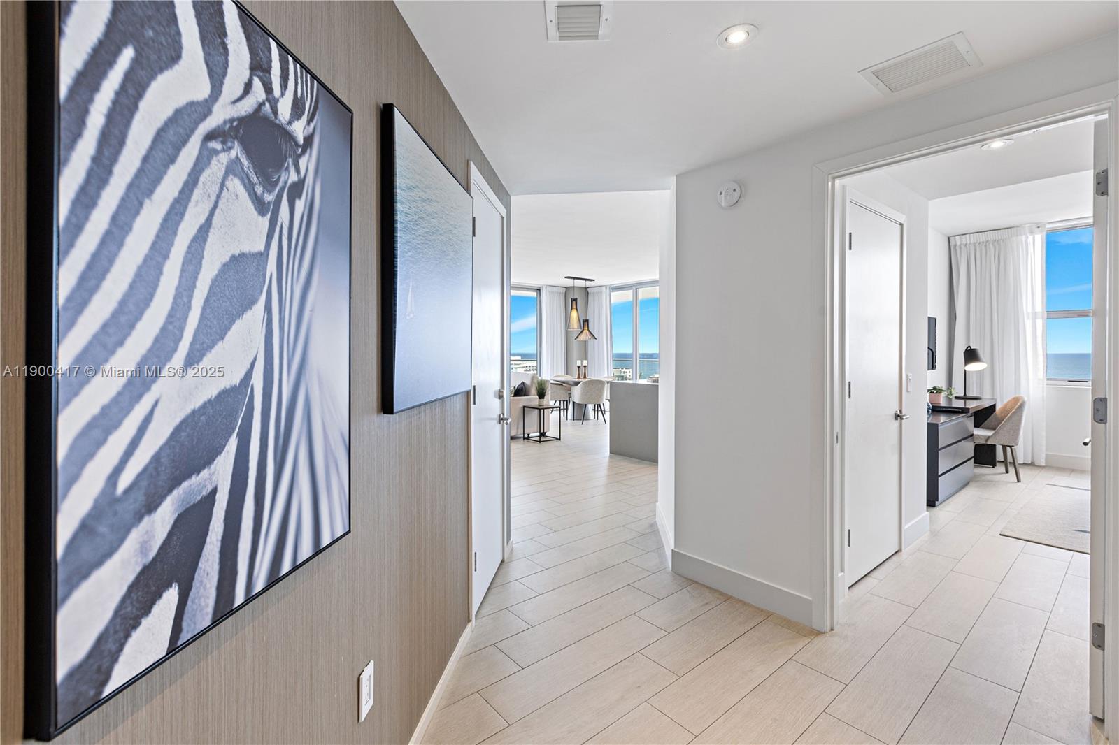 4010 South Ocean Drive, Unit R1701 Hollywood, FL 33019 - Photo 6 of 48 a view of a hallway with dining area and chandelier